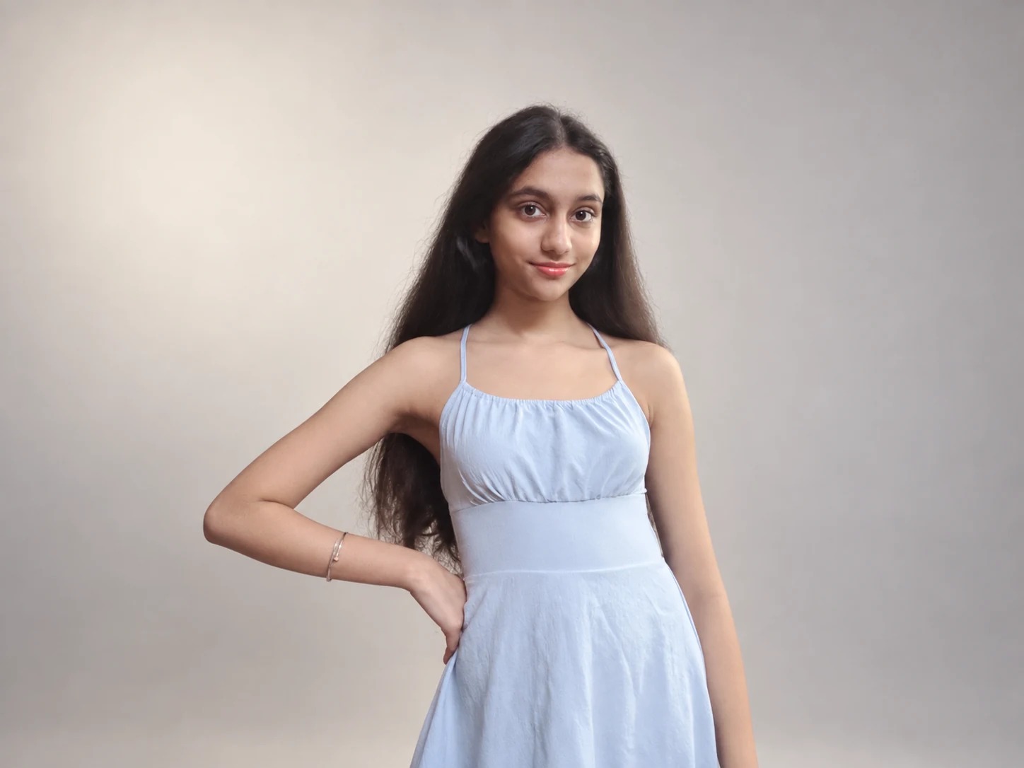 Sreejata facing the camera in her pale blue dress