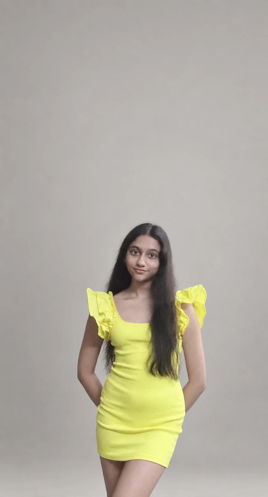 A standing portrait of Sreejata in her yellow dress