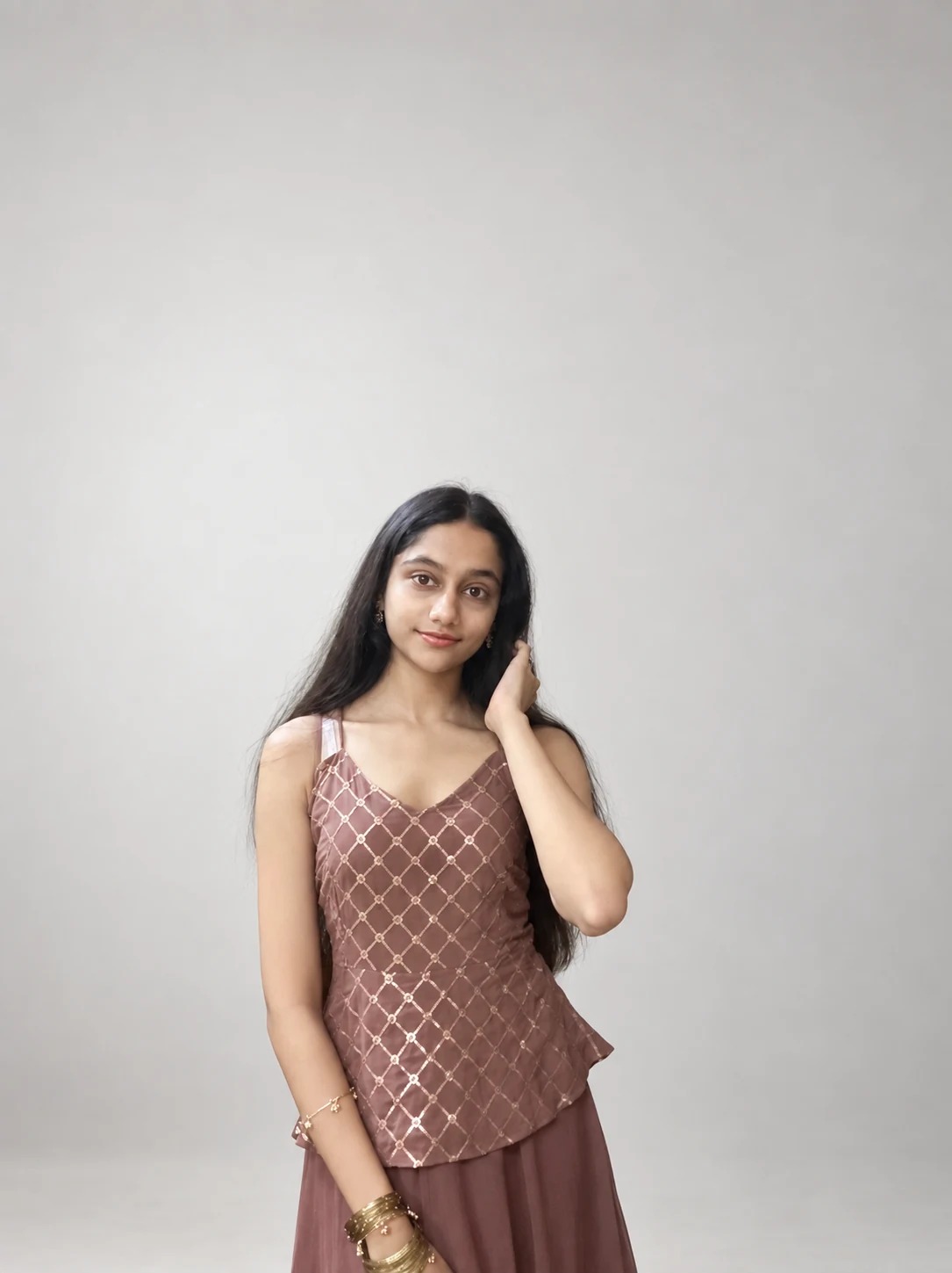 Sreejata standing in her brown patterned outfit