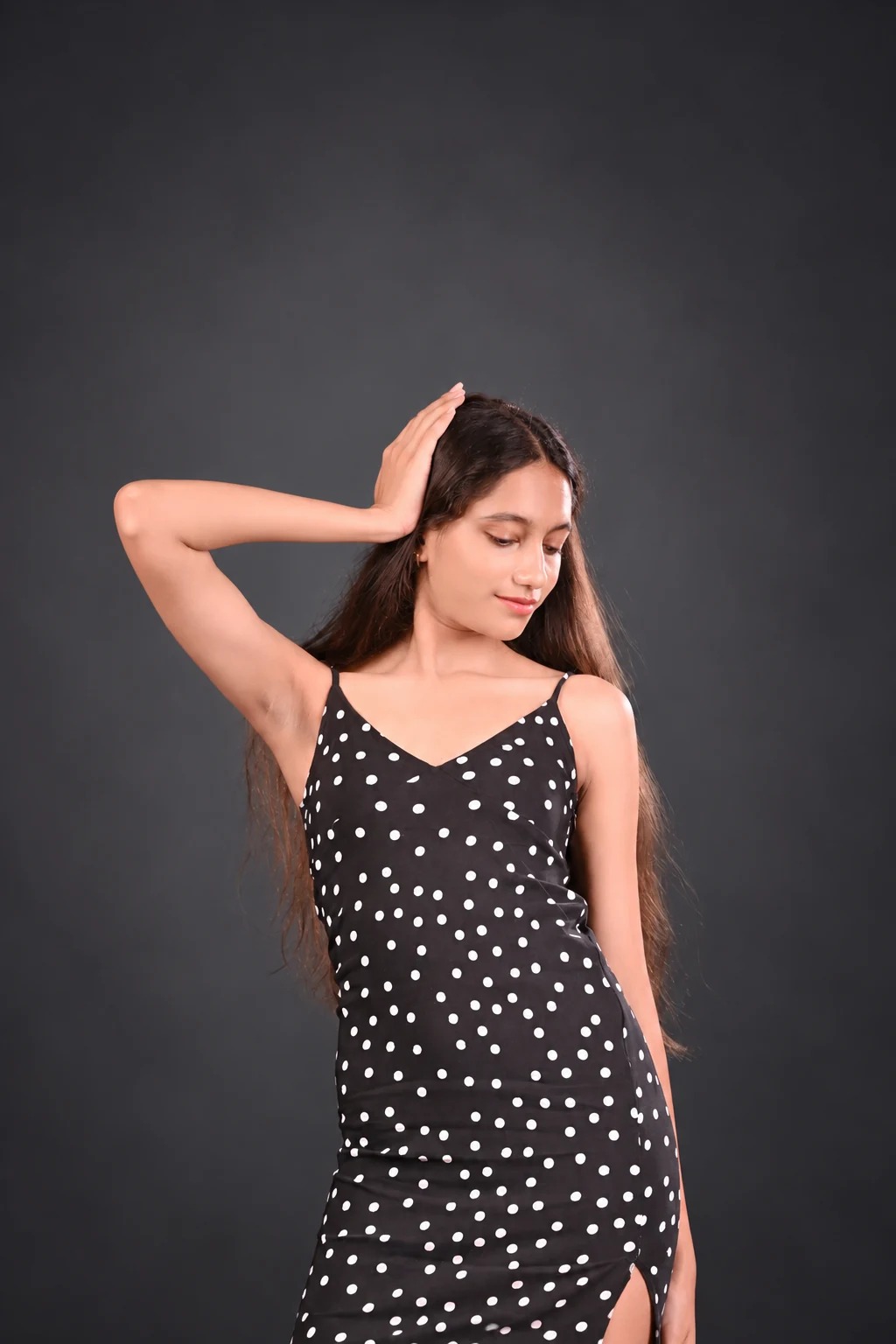 Sreejata in her polka-dot dress with her hand above her head